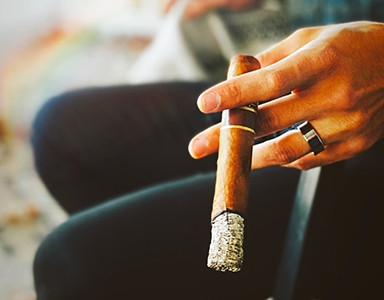 Why keep the ash when smoking a cigar?